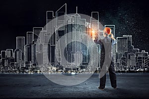 Builder man using media interface . Mixed media