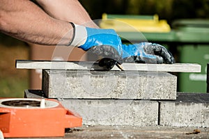 Builder marking a paving stone or block to cut