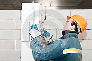 Builder mason at bricklaying work