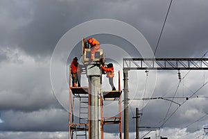 Builder in orange working on concrete piles