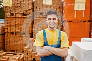 Builder at the pallets of bricks in hardware store
