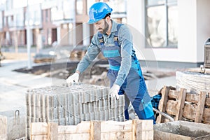 Builder with paving blocks outdoors