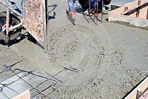 The builder is pouring cement  new building construction.