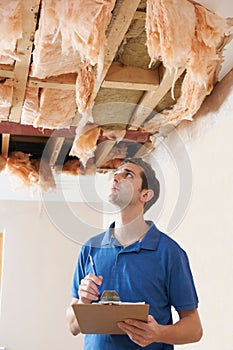 Builder Preparing Quote For Damage To Ceiling