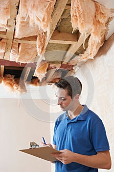 Builder Preparing Quote For Damage To Ceiling