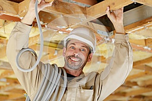 Builder putting or repairing up suspended ceiling