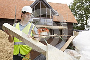 Builder Putting Waste Into Rubbish Skip