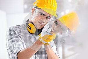 Builder reflected in glass on site