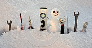 Builder repair tools. Little snowman with repairing instrument. Snow man worker.