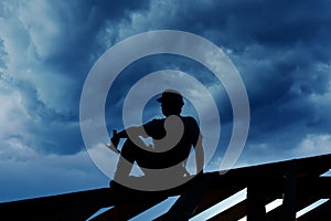 Builder resting on top of roof