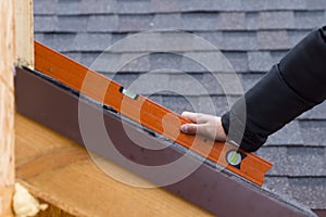Builder or roofer holding a spirit level
