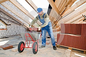 Builder roofer and wheel barrow photo