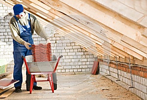 Builder roofer and wheel barrow photo