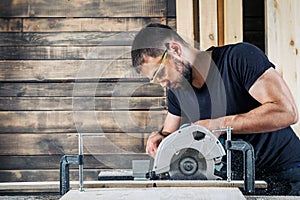 Builder saws a board