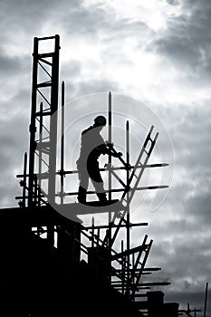 Builder on scaffold building site