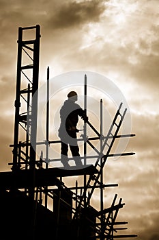 Builder on scaffold building site