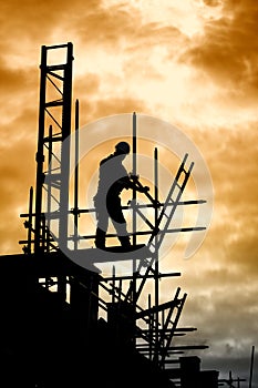 Builder on scaffold building site photo