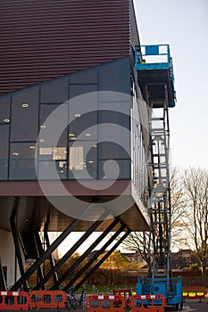Builder on a Scissor Lift Platform at a construction site