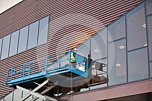 Builder on a Scissor Lift Platform at a construction site