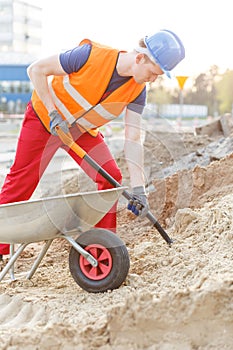 Builder with shovel and barrow