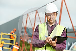 Builder site manager worker at construction site photo