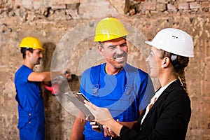 Builder and supervisor on construction site