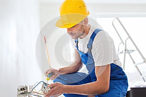 Builder with tablet pc and equipment indoors