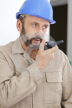 Builder talking in walkie-talkie