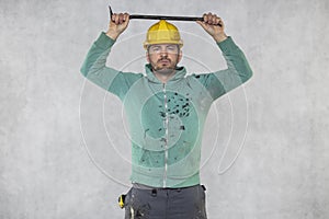 The builder tests the strength of the protective helmet