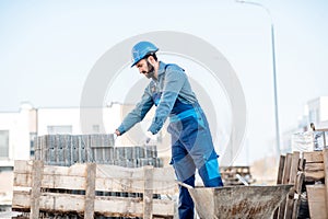 Builder with paving blocks outdoors