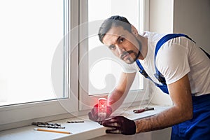 The builder uses the level on the windowsill