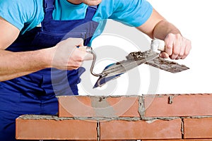 Builder using a cement and trowel