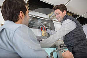 builder using metal snips on aluminium shutter