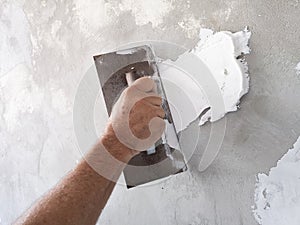 Builder using plastering tool for finishing old wall