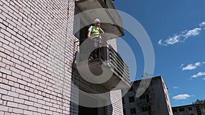 Builder on walkie talkie shows thumb down