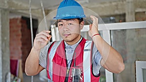 builder wearing hardhat at construction site