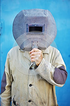 Builder - welder with old welding mask