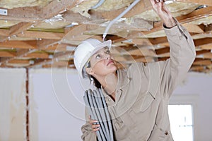 Builder woman holding cables