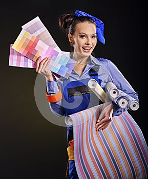 Builder woman with wallpaper