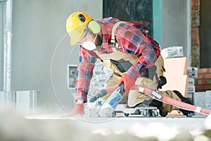 Builder at work. cutting concrete floor for cabling by diamond slitting machine