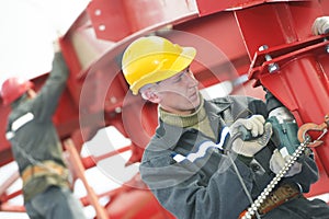 Builder worker assembling metal construction