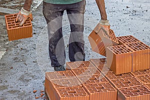 Builder worker carrying hollow clay block