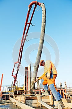 Builder worker at concrete pouring work