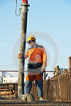 Builder worker at concrete pouring work