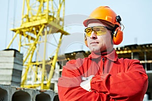 Builder worker at construction site photo