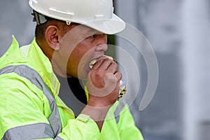 Builder worker eats at construction site