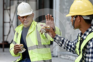 Builder worker eats at construction site