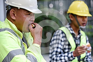 Builder worker eats at construction site