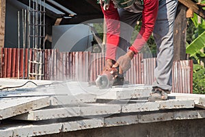 Builder worker with grinder machine cutting concreate floor