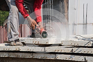 Builder worker with grinder machine cutting concreate floor